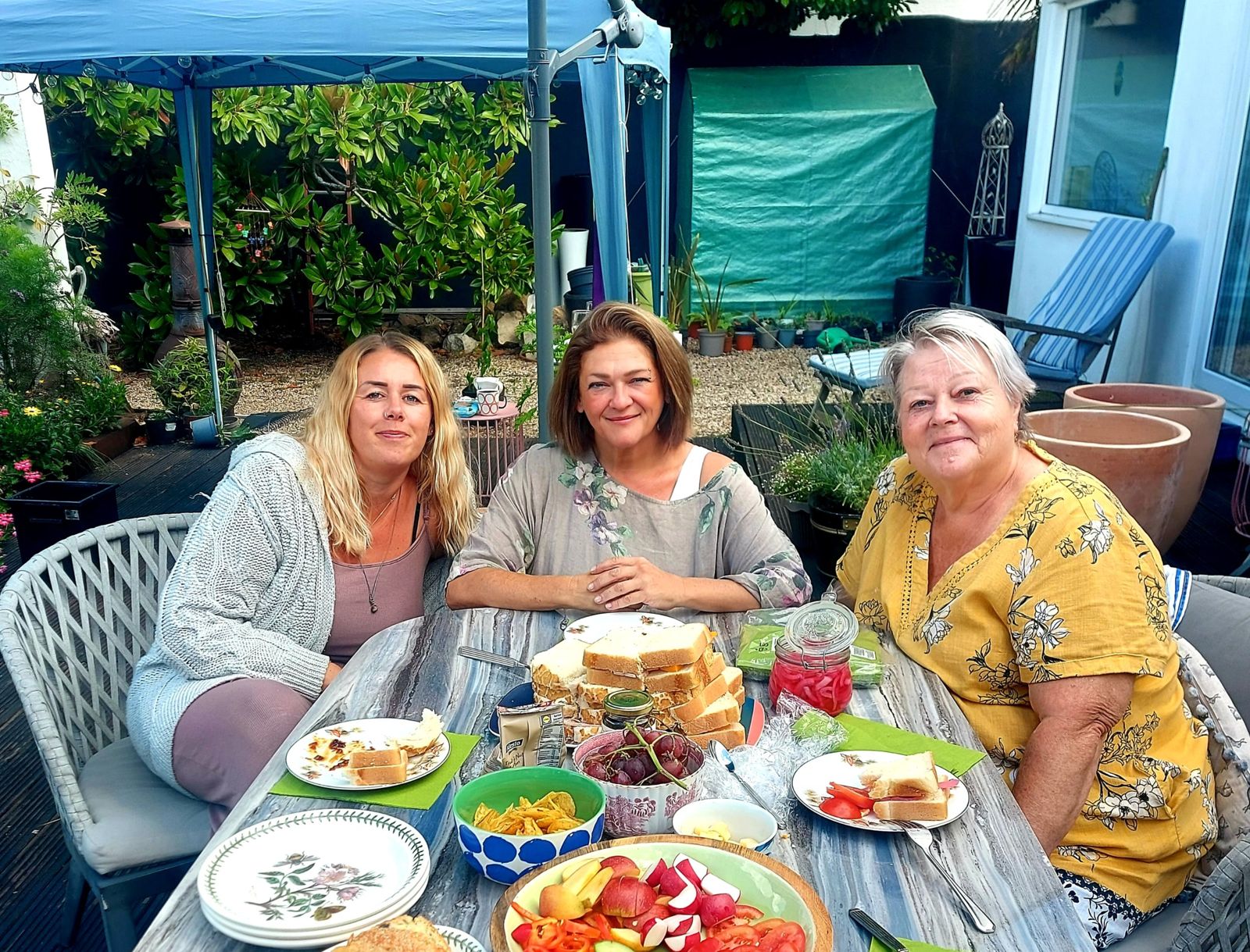 Nikki with friends at a garden table on a Friends therapy day