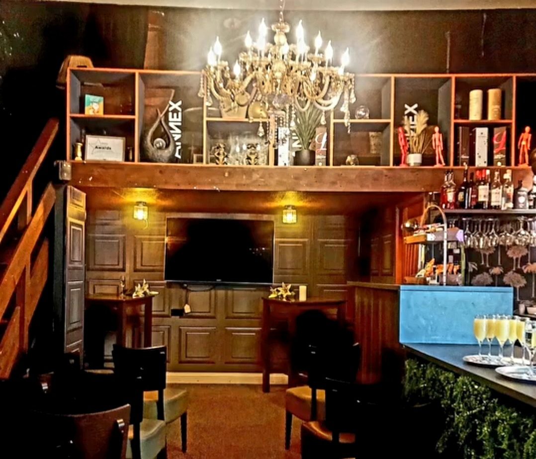 A venue set up with chandelier and bar, ready for an evening with Nikki
