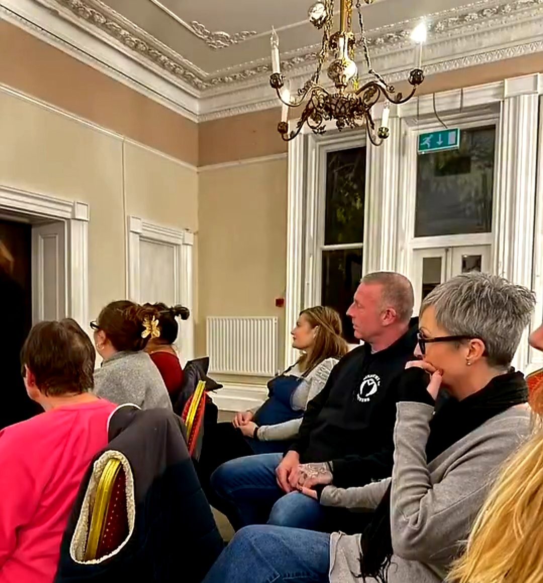 An audience listening to Nikki at a public event