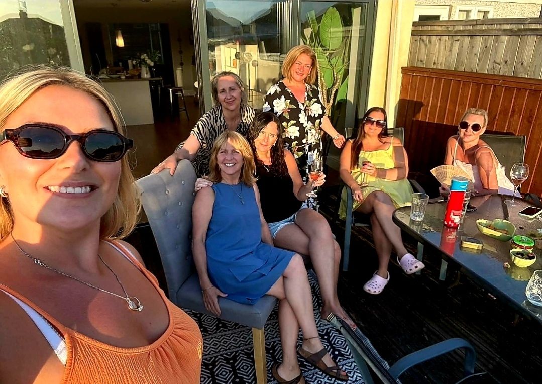 Friends enjoying a sunny evening on a patio together
