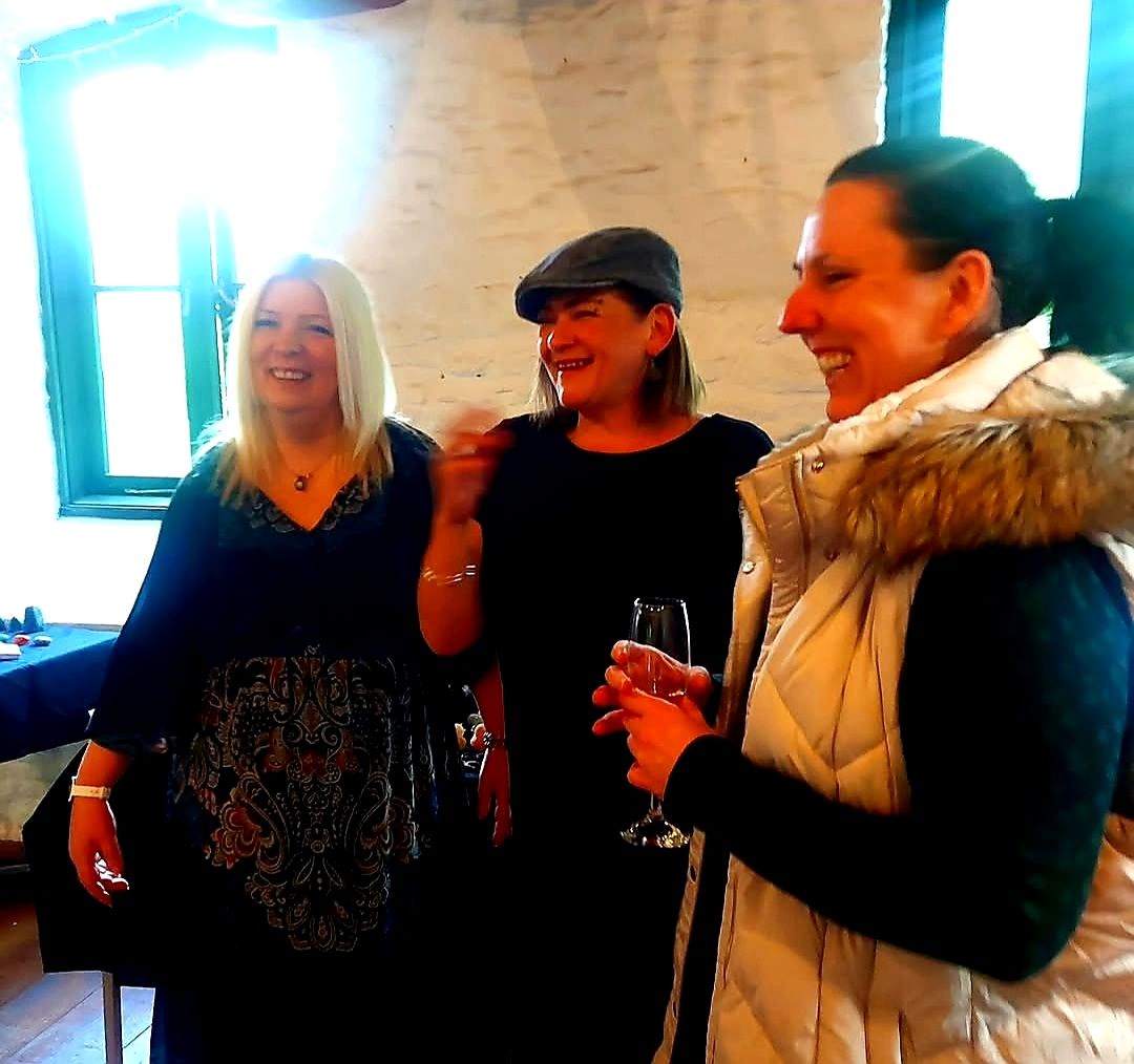 Nikki laughing with guests at a barn event
