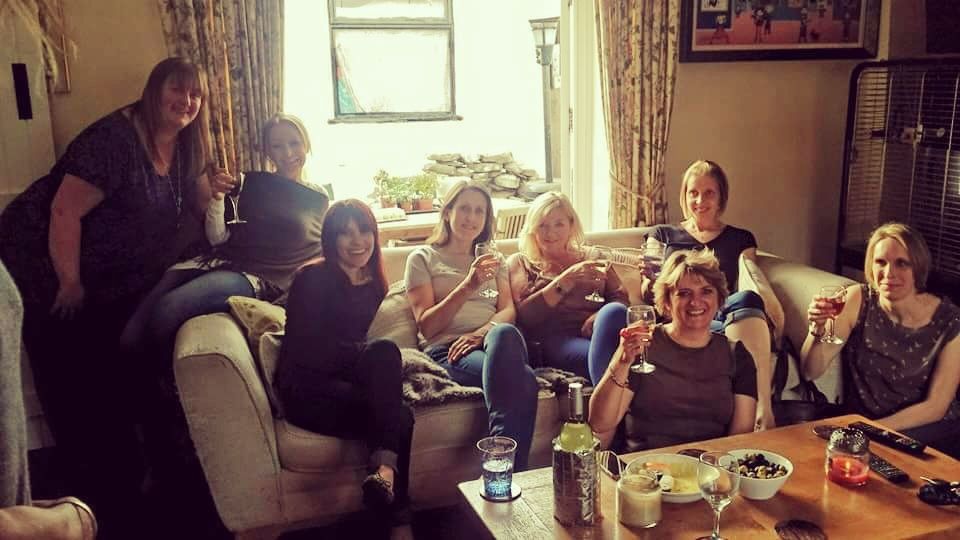 Friends raising a glass in a living room at an evening with Nikki