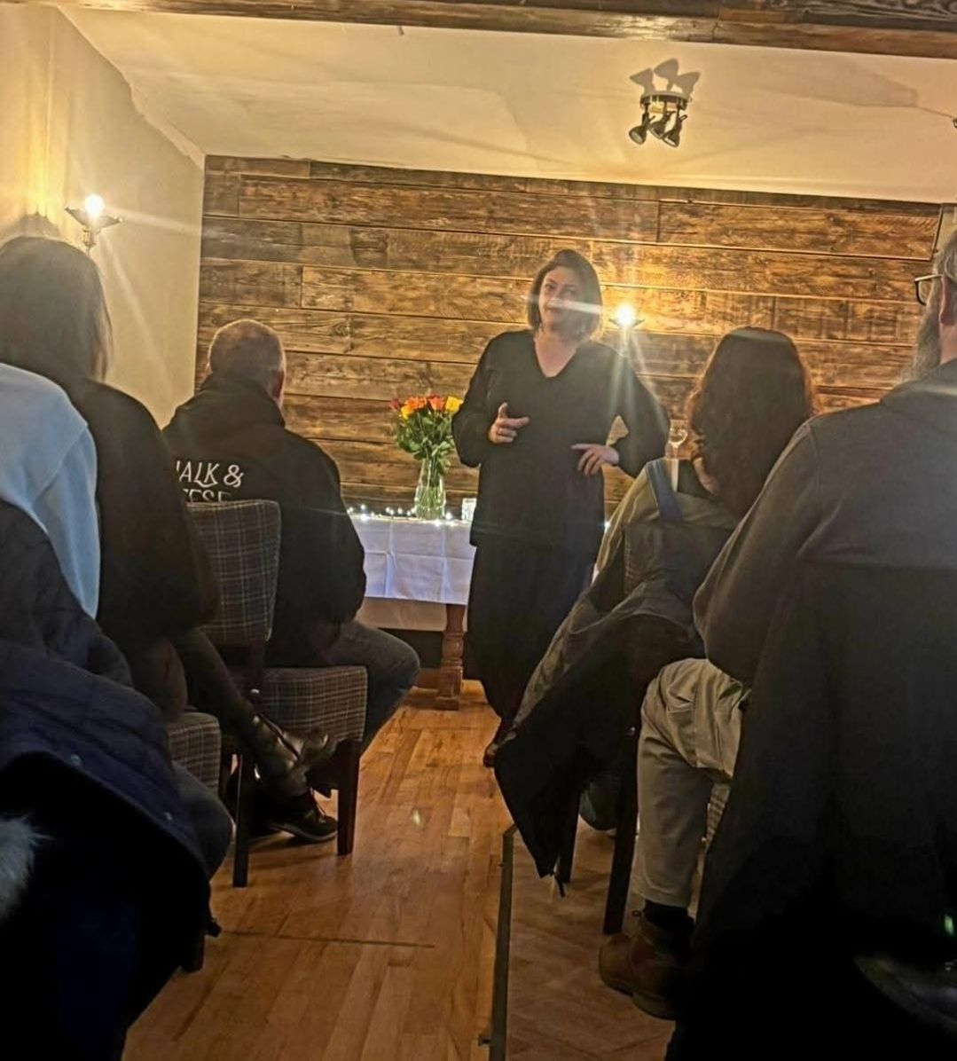 Nikki speaking to the audience at a pub event