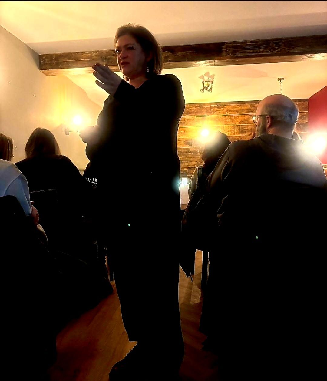 Nikki giving a reading at an evening event
