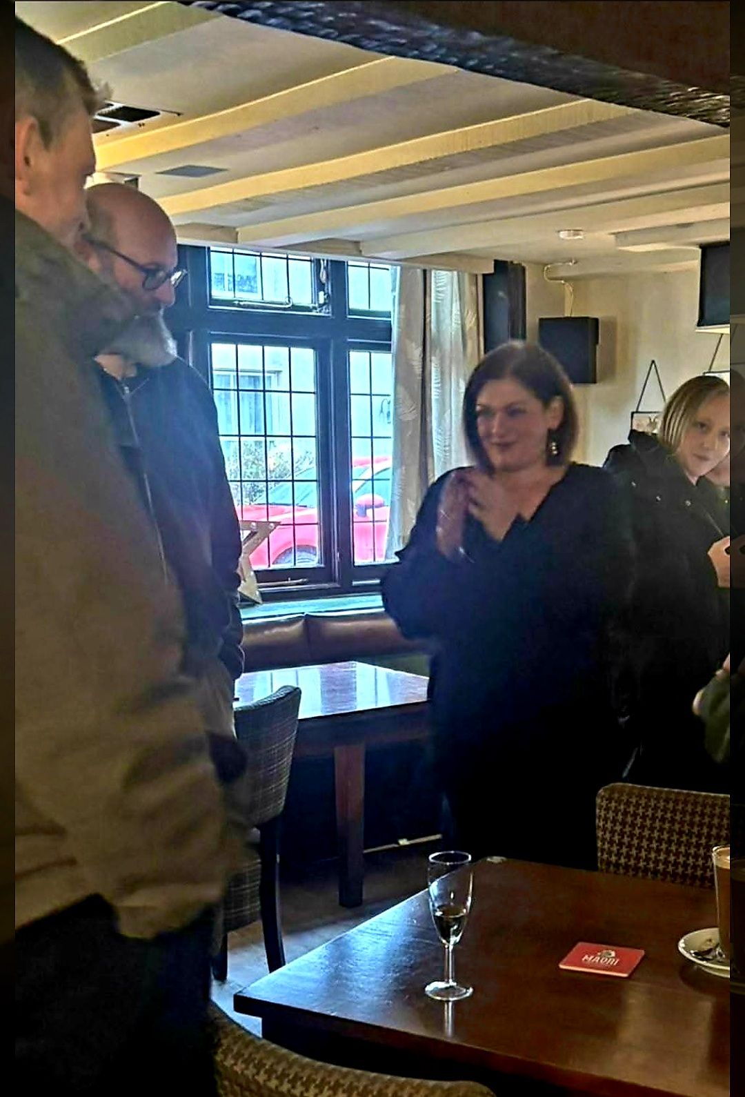 Nikki talking with guests at a pub event