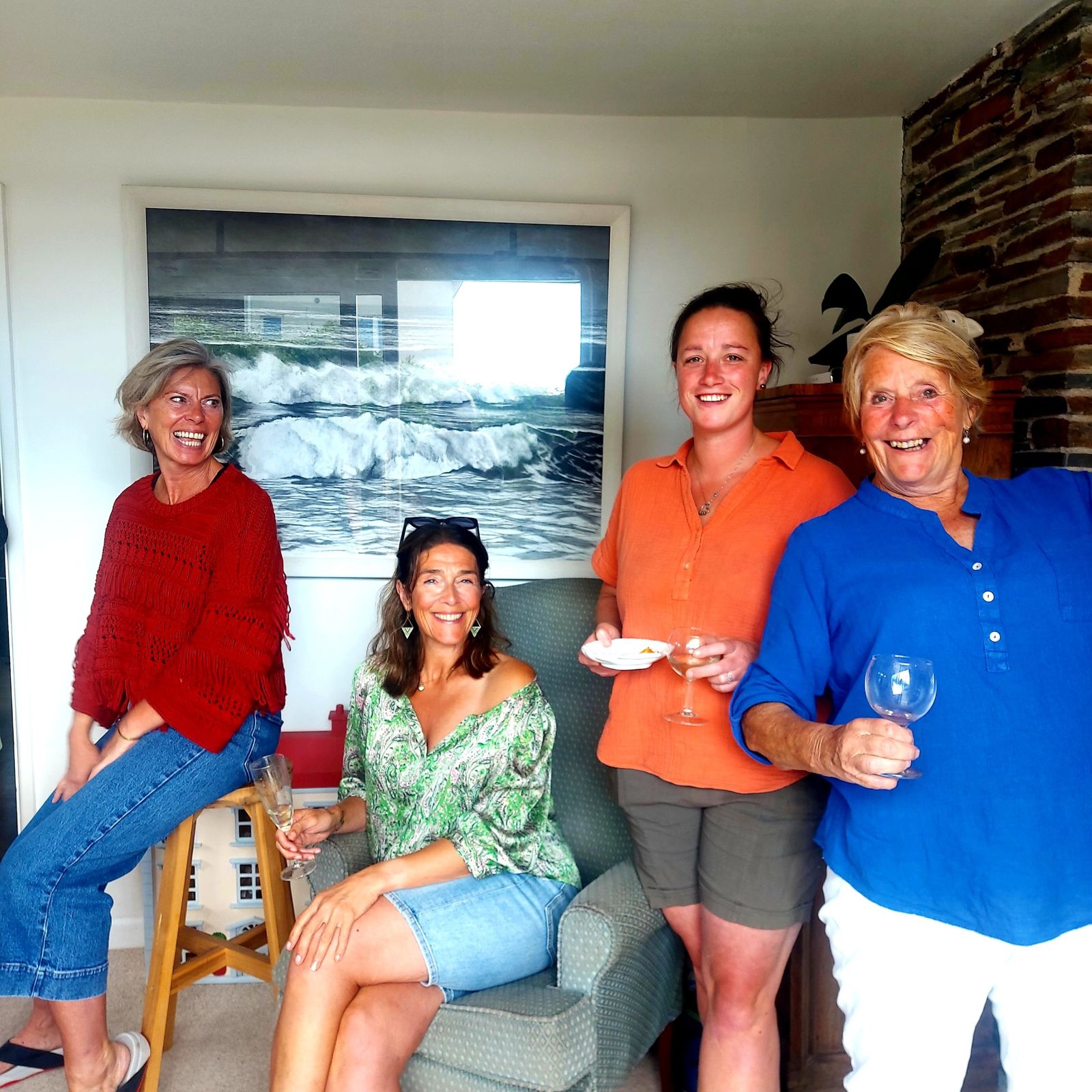 Four friends laughing with drinks on a Friends therapy day